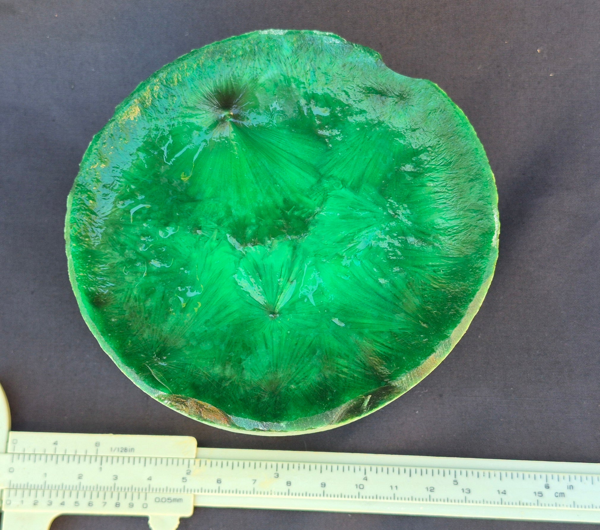 Green chatoyant glass boule 1155g - flat lay with ruler