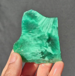 Green chatoyant glass slab 42g - hand held view