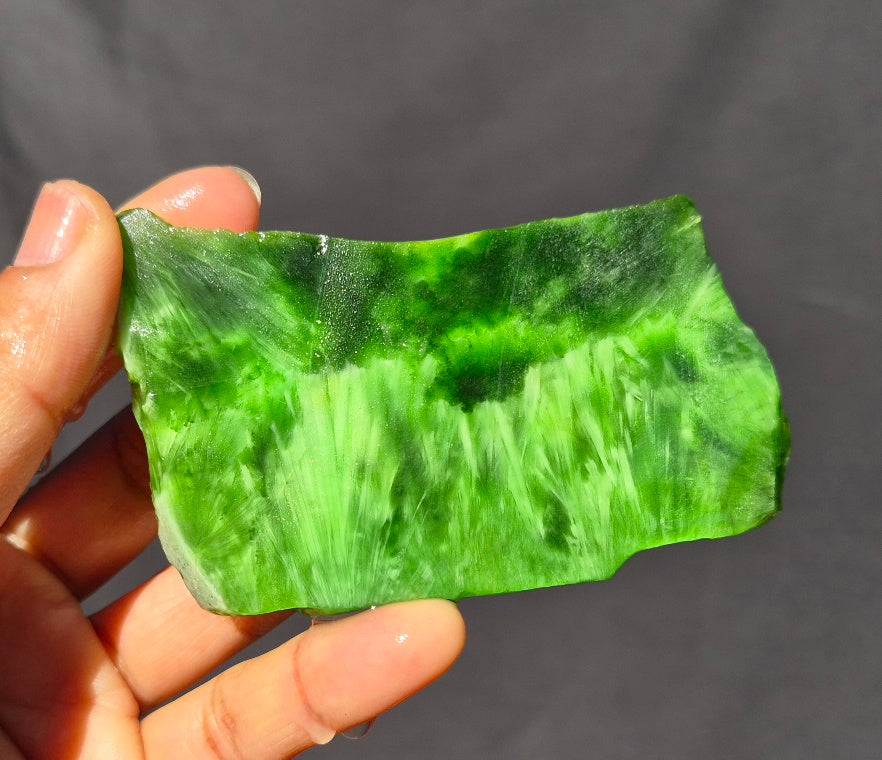 Green chatoyant glass slab 69g - hand held view