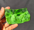 Green chatoyant glass slab 69g - hand held view