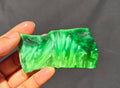 Green chatoyant glass slab 47g - hand held view