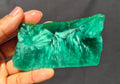 Green chatoyant glass slab 73g - hand held view