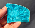 Teal blue chatoyant glass slab 49g - hand held view