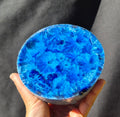 Blue chatoyant glass boule 1352g - hand held view showing crystalline starburst patterns