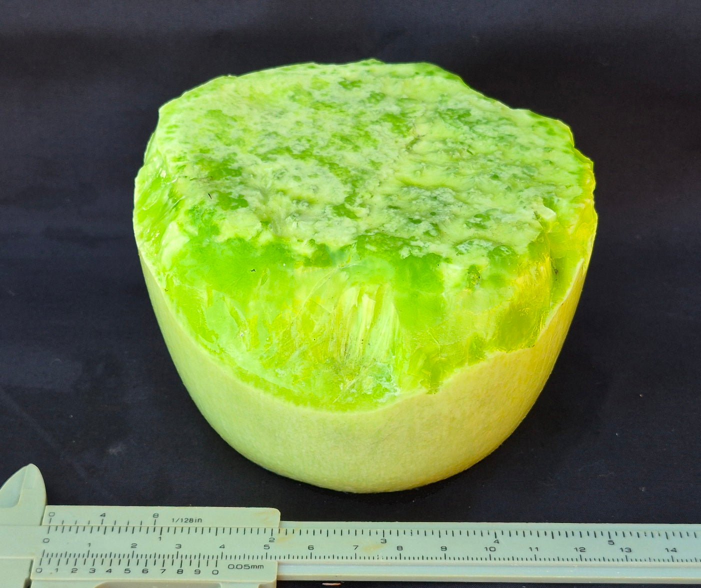 Lime green chatoyant glass boule 1440g - flat lay with ruler