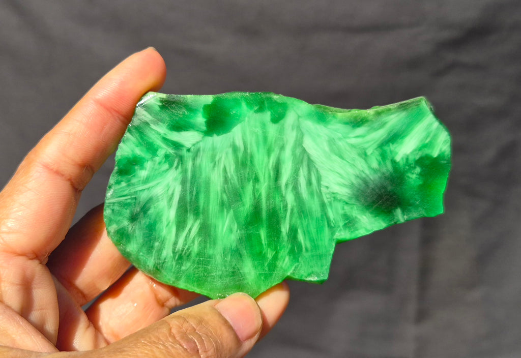 Green chatoyant glass slab 81g - hand held view