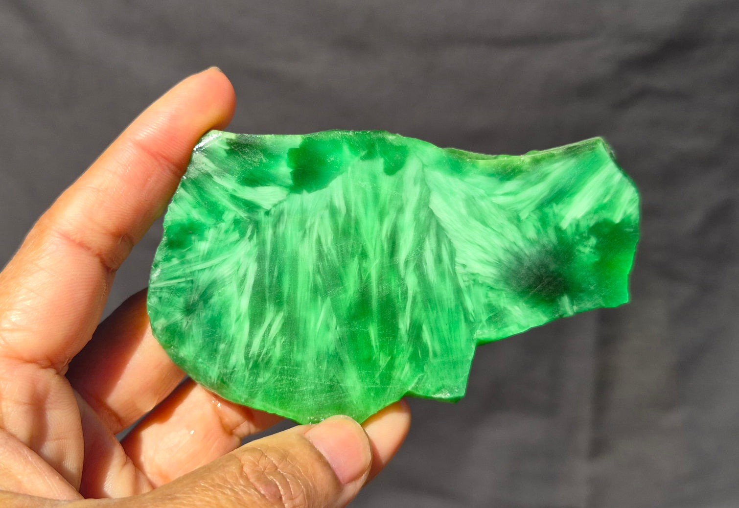 Green chatoyant glass slab 81g - hand held view