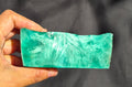 Green raw chunk 451g – SBSR 115, hand held showing chatoyancy