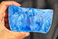 Blue raw chunk 655g – SBSR 119, hand held showing vivid blue chatoyancy