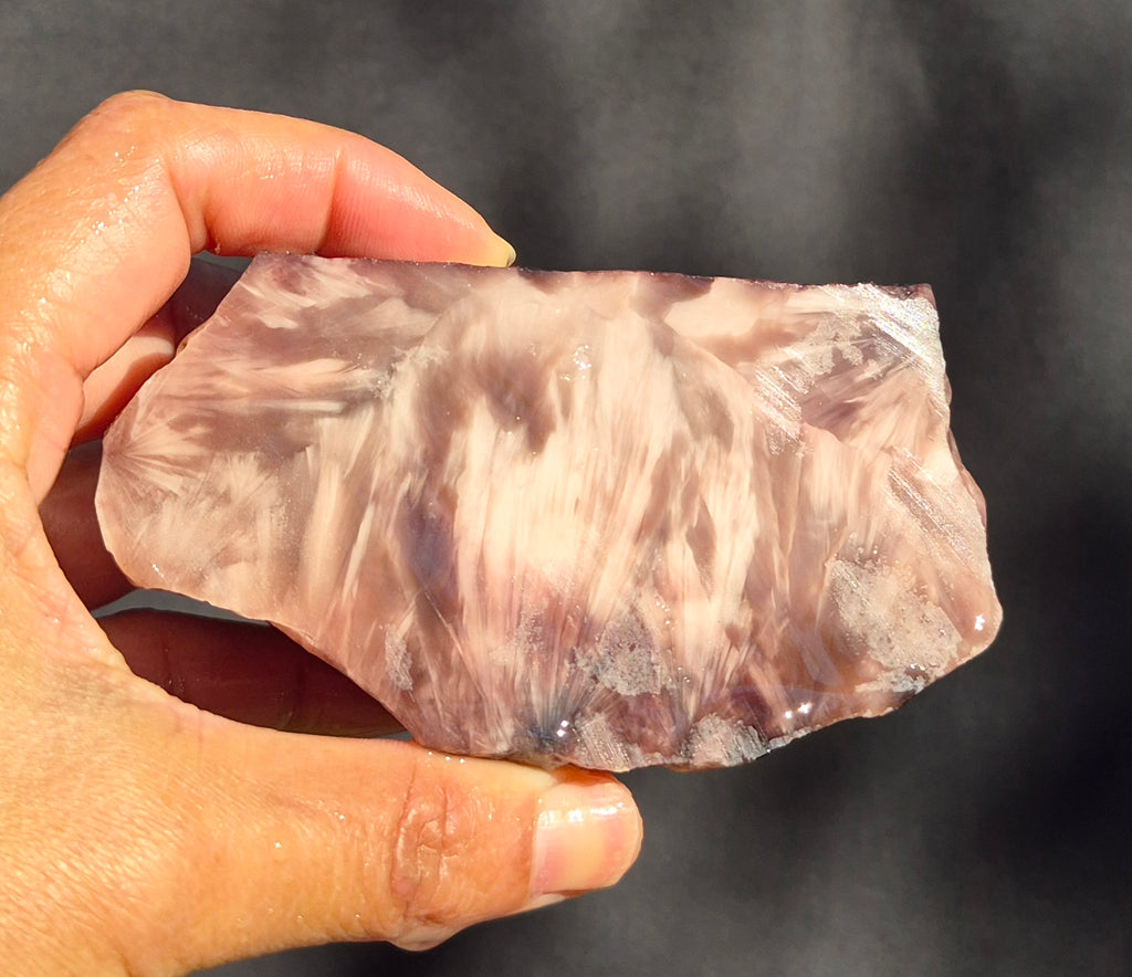 Plum raw chunk 369g – SBSR 118, hand held showing chatoyancy