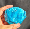 Blue chatoyant glass raw chunk SBSR 133 - hand held front view