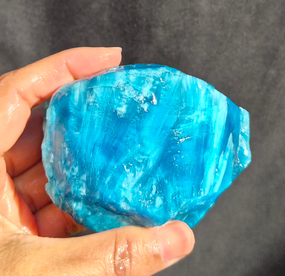 Blue chatoyant glass raw chunk SBSR 133 - hand held front view