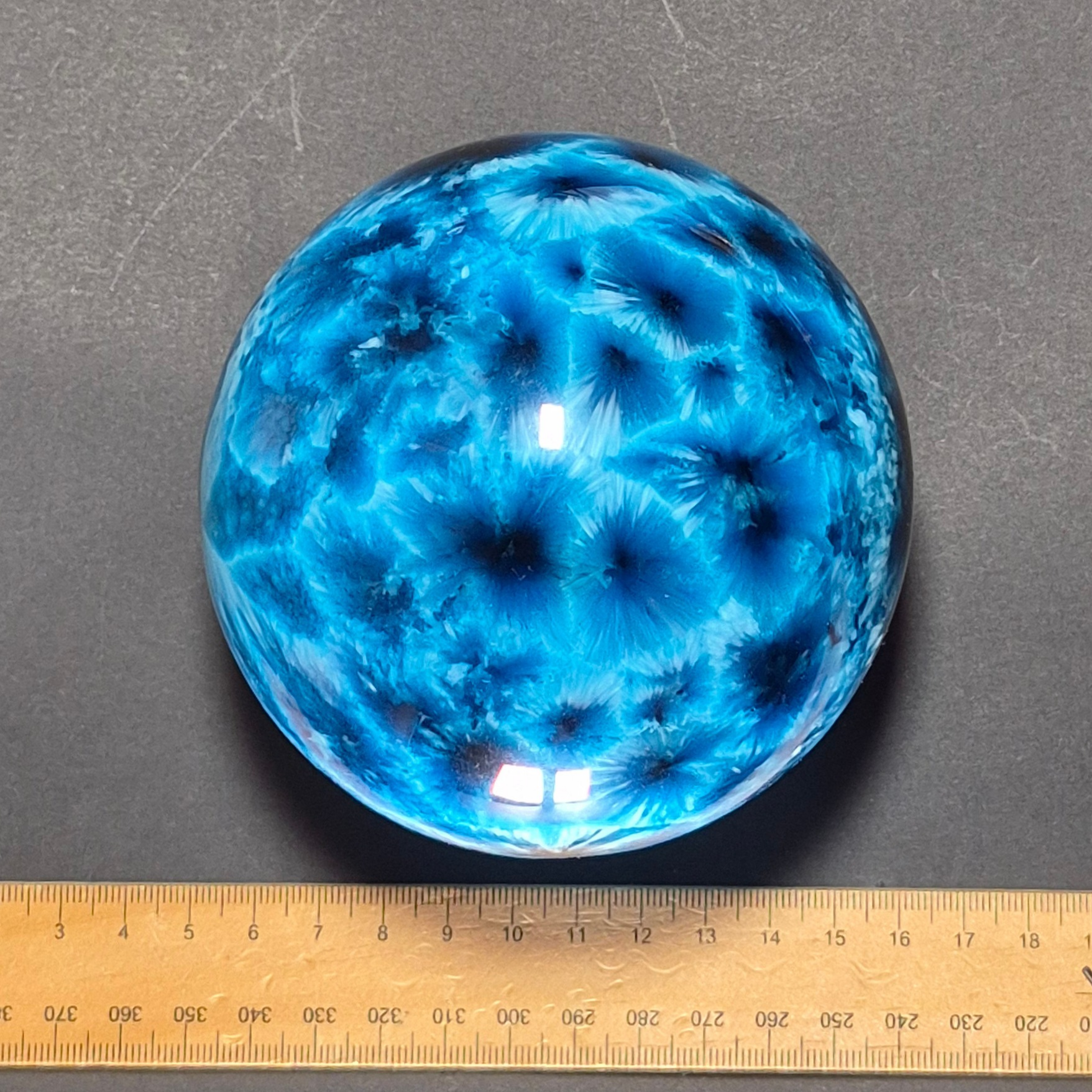Starburst Glass Sphere Ocean Blue with ruler showing 100mm diameter