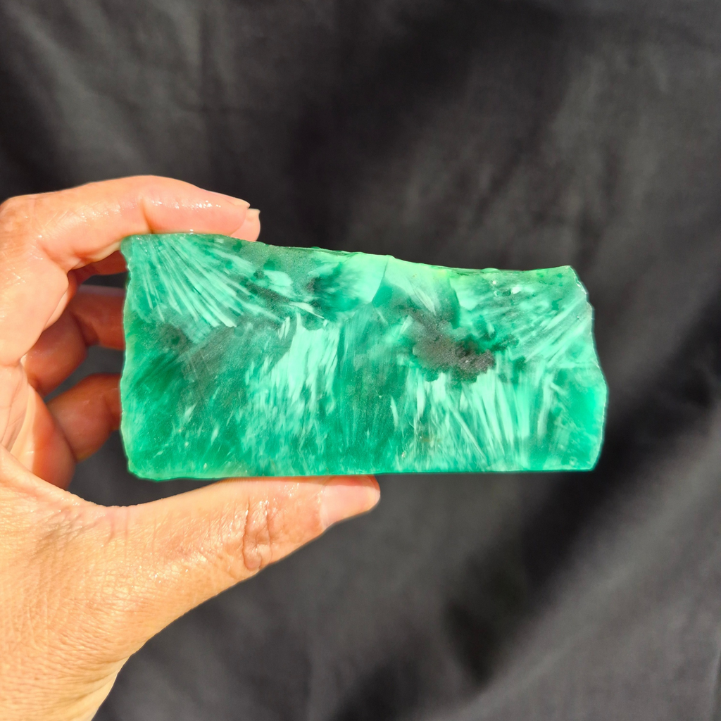 Green chatoyant glass raw chunk SBSR 132 - hand held front view