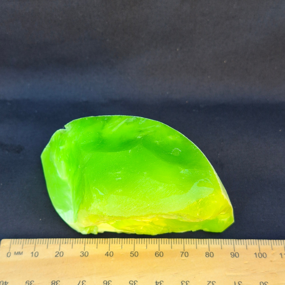 Lime green chatoyant glass raw chunk - side view