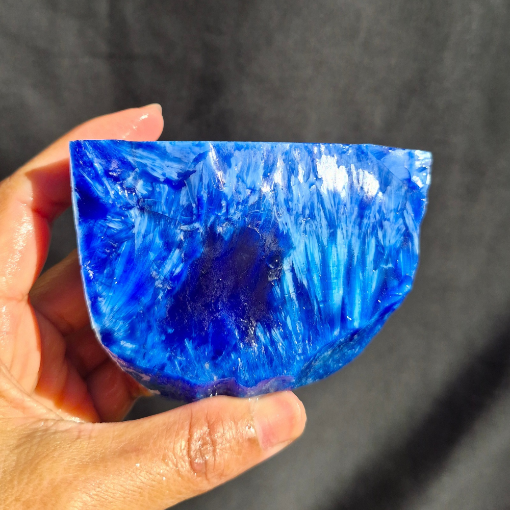Cobalt blue chatoyant glass raw chunk SBSR 129 - hand held front view