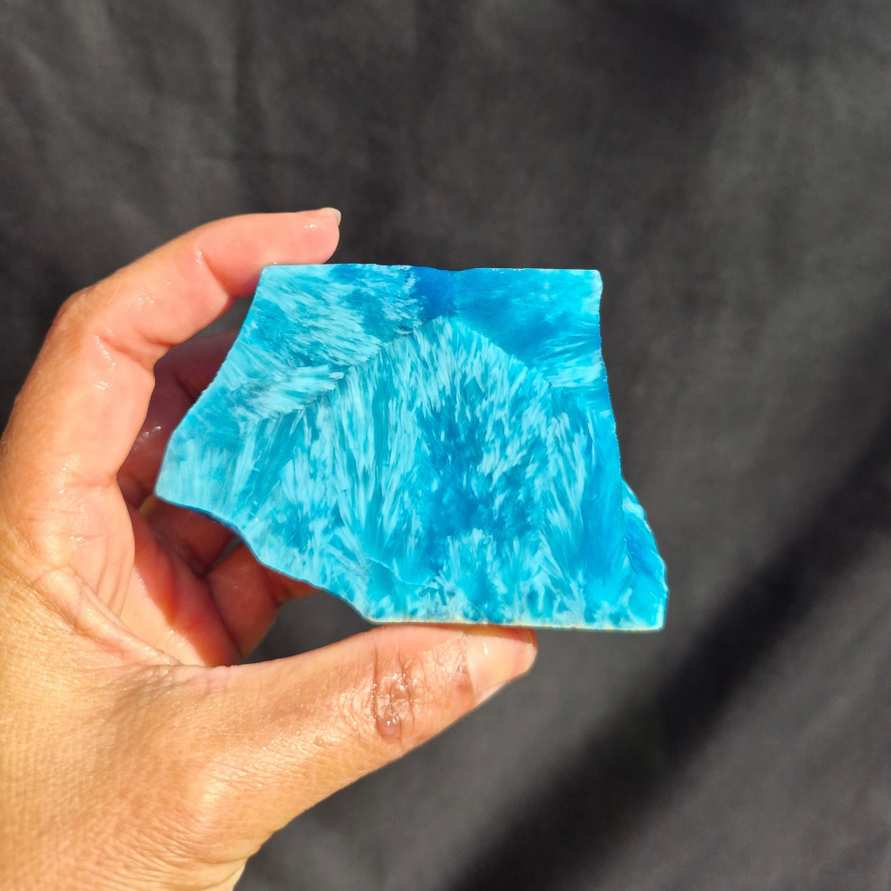Aqua blue chatoyant glass raw chunk SBSR 131 - hand held front view