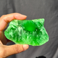 Green chatoyant glass slab 76g - hand held view
