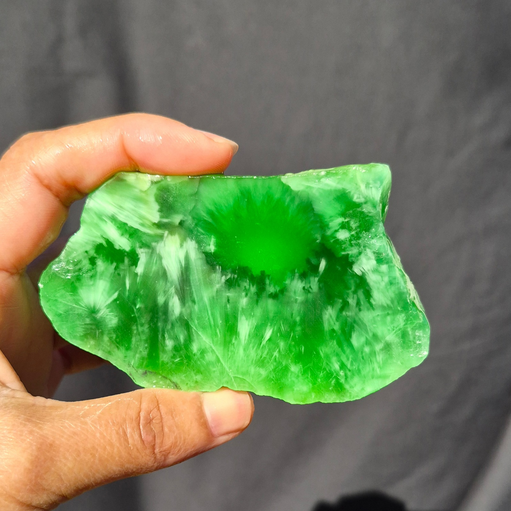 Green chatoyant glass slab 76g - hand held view